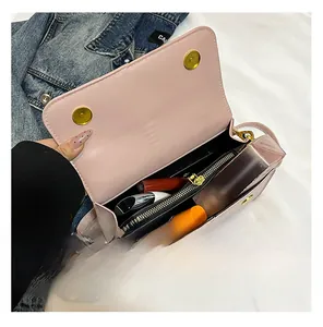 Detail of pink leather crossbody bag interior showing organized zipper compartment and cosmetics