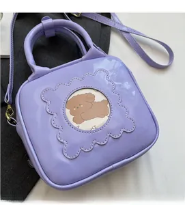 Detail of purple patent leather handbag with cartoon dog window and removable shoulder strap