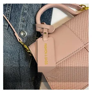 Detailed view of pink crossbody bag with woven texture, smooth leather, and gold hardware