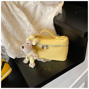 Yellow box handbag in litchi grain faux leather with a cute plush puppy charm