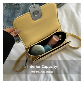 Internal capacity of the pale yellow crossbody bag showing storage for makeup items