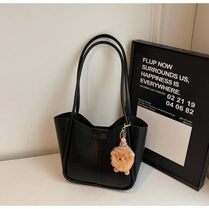 Minimalist black matte faux leather bucket bag with cute brown plush charm detail