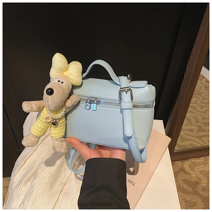 Detailed macro view of the light blue lychee pattern leather texture and silver hardware