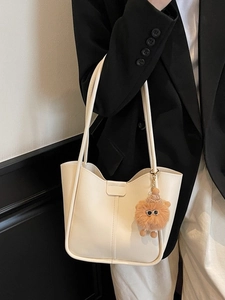 Minimalist off-white leather tote bag with lion plush pendant for commute and office