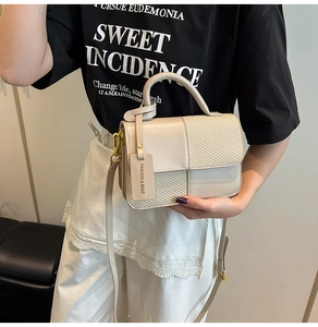 Detail of contrast color crossbody bag featuring beige leather and woven texture mix