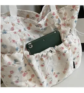 Detail of floral lace tote bag featuring functional drawstring pocket and large storage space