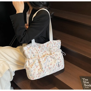 Floral tote bag featuring drawstring closure and side pockets for casual daily use