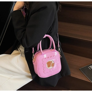 Pink glossy square handbag with wavy clear window and cute bear motif detail