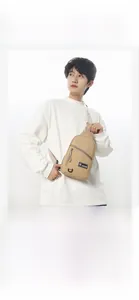 Détail d'un sac bandoulière kaki avec sangle réglable porté par un mannequin homme