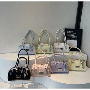 Boston bag showcase in seven pastel colors featuring bow ribbons and heart charms