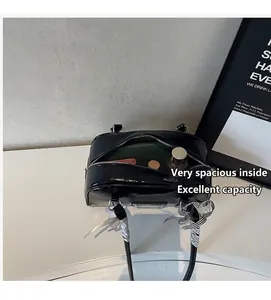 Interior view of black glossy shoulder bag showing spacious storage for cosmetics