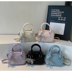 Detailed arrangement of stylish pastel handbags with silver chain and bow charms