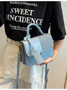 Contrast color light blue crossbody bag with woven texture and gold hardware details