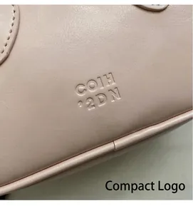 Macro shot of pink lychee leather handbag featuring embossed COIH 22DN logo detail