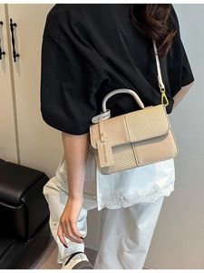 Chic beige crossbody bag with contrast stitching and woven texture shown in lifestyle setting