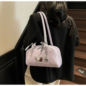 Detail of light purple PU leather shoulder bag with checkered bow and heart charm