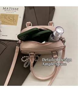 Top view of pink handbag showing interior storage capacity for phones and cosmetics
