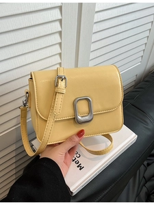 Elegant pale yellow minimalist chain square bag with silver metallic clasp and shoulder strap