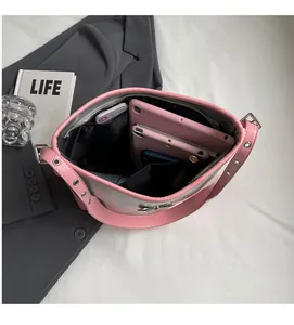 Spacious interior of silver bow shoulder bag with large capacity for tablets and daily items