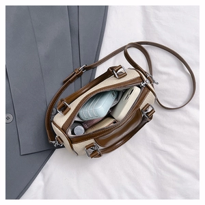 Interior view showing the capacity of a contrast Boston bag with a phone and power bank