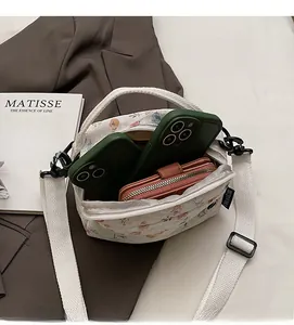 Detail view of the floral mini square bag showing interior space for phones and wallet