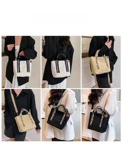 Detail of multi-functional canvas tote bags in white and black with GENTLEWOMAN strap