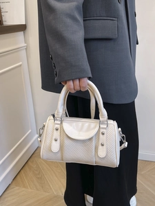 Two-tone woven pillow handbag with metal studs and top handle for women
