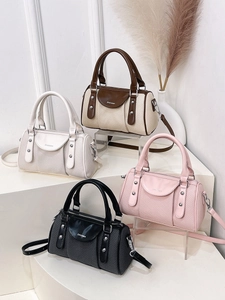 Four colors of minimalist woven boston bags with leather trim and shoulder straps