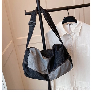 Detail of vintage denim tote bag showing patchwork fabric texture and shoulder strap