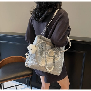Silver snake-pattern tote bag with pearl chain and white cloud charm details