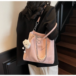Pink snake-embossed tote bag with thick metal chains, pearl charms, and cloud pendant