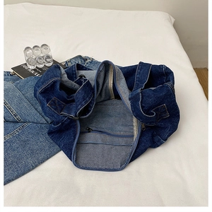Detailed interior of denim tote bag showing the zipper pocket and large capacity