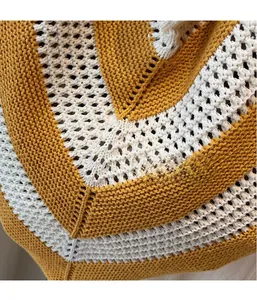 Macro detail of high-quality yellow and white striped knit fabric with hollow texture