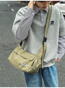 Close-up of army green nylon crossbody bag with flap and adjustable strap details