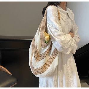 Close-up of bohemian crochet knit tote bag with yellow tulip detail and wavy pattern