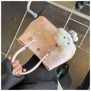 Pink glossy leather tote bag with white cloud plush charm and top handles