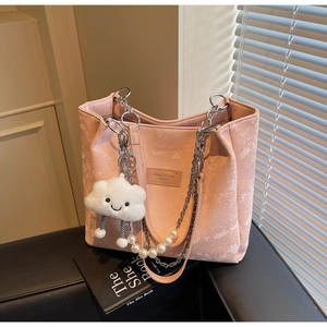 Detail of pink snakeskin tote bag with silver chain, pearl strap and plush cloud charm
