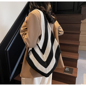 Macro detail of black and white chevron knit pattern on this large hobo shoulder bag