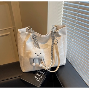 Detail of white tote bag with snake texture, pearl chain, and plush cloud charm decor