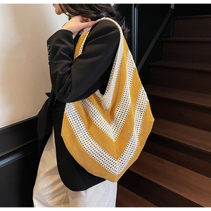 Close-up of yellow chevron crochet tote bag showing hollow knit texture and large capacity
