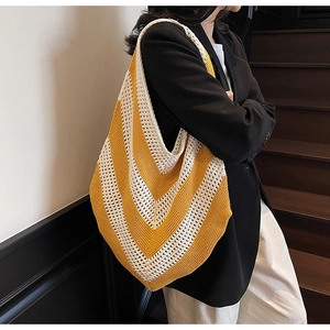 Detail of hand-knitted tote bag with yellow chevron pattern showing textured weave