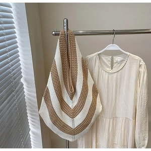 Detailed close-up of brown and cream chevron knit pattern on a large beach tote bag