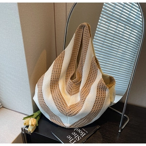 Detail of hand-woven knit tote bag featuring brown and white V-shaped striped texture