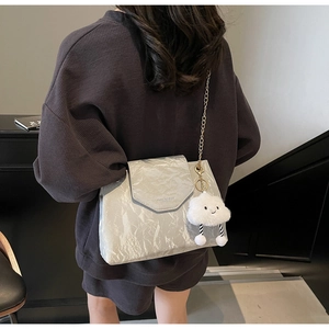 Silver metallic pleated shoulder bag with gold chain strap and plush cloud charm detail