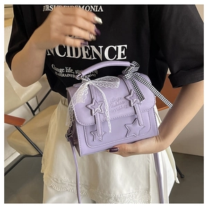 Detail of lavender star handbag with lace ribbon and embossed fashion quote lettering