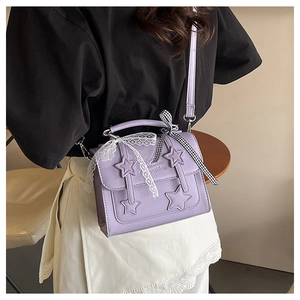 Detail of purple square bag with star patches, white lace bow and checkered ribbon