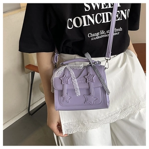 Detail of lavender star messenger bag featuring lace ribbons and black-white checkered bow