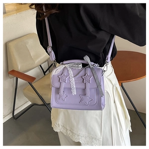 Detail of lavender star crossbody bag featuring lace bow and Fashion embossing