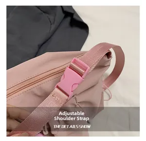 Detail of adjustable pink shoulder strap with buckle for nylon commuter tote bag