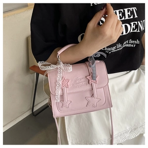 Pink star messenger bag with lace and checkered bow detailing on a model's hand